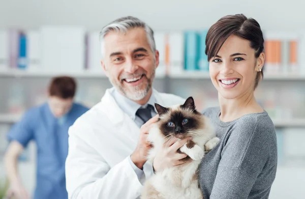 Vet and woman with a cat